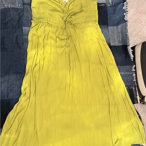 Vibrant Lime Green Dress with Lace-Up Detail and ruffle edge.